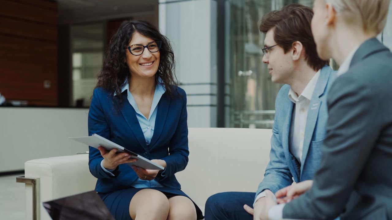 Contact Professionals discussing business strategy in a corporate office setting.